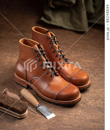 Handcrafted brown leather shoes with cobbler tools 86248694