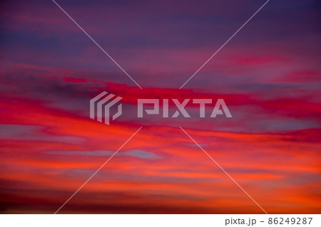 Vivid colourful clouds Dramatic Sky At Sunrise or Sunset. Orange red pink sky with beautiful clouds in sunlight background. Gradient cold to warm at sunset. Defocused abstract background Vivid colourful clouds Dramatic Sky At Sunrise or Sunset. Orange red pink sky with beautiful clouds in sunlight background. Gradient cold to warm at sunset. Defocused abstract background 86249287