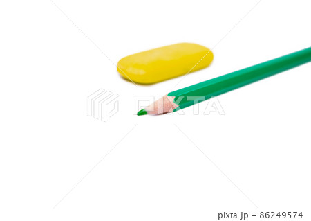 green pencil and yellow eraser on white background 86249574