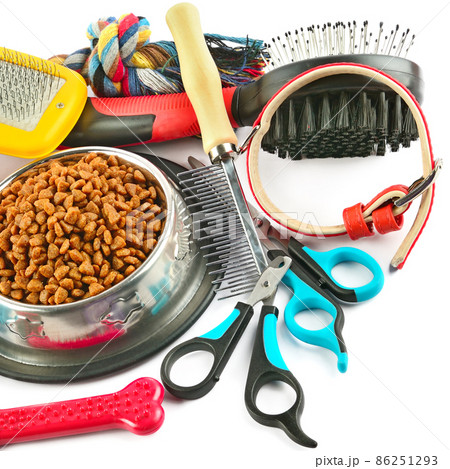 Pet accessories concept. Dry food and rubber toys for pet isolated on white background. Pet accessories concept. Dry food and rubber toys for pet isolated on white background. 86251293