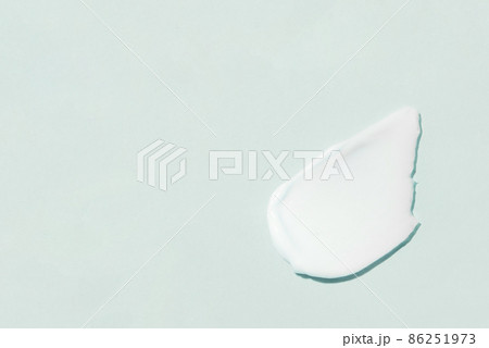 Smear of cosmetic cream on a blue background. Smear of cosmetic cream on a blue background. 86251973