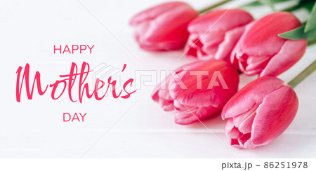 Fresh tulip flowers on a white wooden background. Bright spring background. Mother's Day Concept. Fresh tulip flowers on a white wooden background. Bright spring background. Mother's Day Concept. 86251978