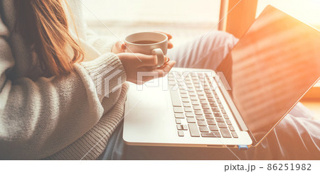 Young woman working in home on her laptop computer. Remote work concept. Young woman working in home on her laptop computer. Remote work concept. 86251982
