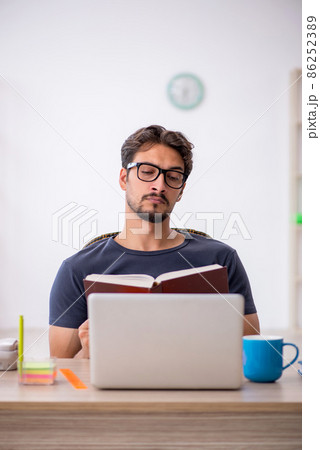 Young male designer working in the office Young male designer working in the office 86252389