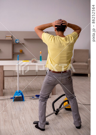 Young man doing housework at home Young man doing housework at home 86252564