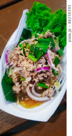 Spicy minced pork salad (Laab) at Thai street food 86256395
