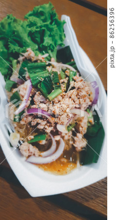 Spicy minced pork salad (Laab) at Thai street food 86256396