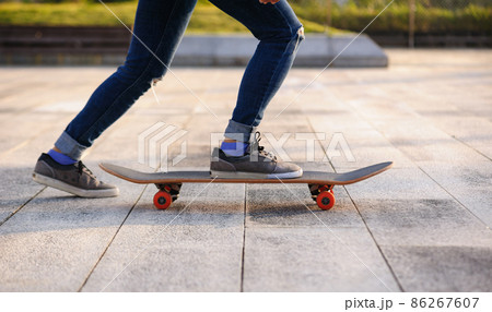 Skateboarder with skateboard outdoors in city Skateboarder with skateboard outdoors in city 86267607