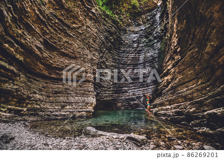 Girl Taking Natural Shower on Waterfall 86269201