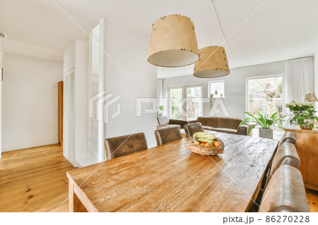 Cute dining room with leather chairs and wooden table 86270228