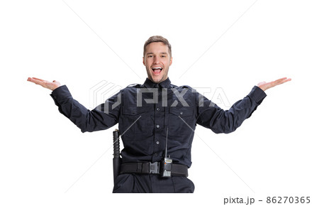 Studio shot young happy man, policeman officer wearing black uniform posing isolated on white background. Concept of job, caree, law and order. Studio shot young happy man, policeman officer wearing black uniform posing isolated on white background. Concept of job, caree, law and order. 86270365