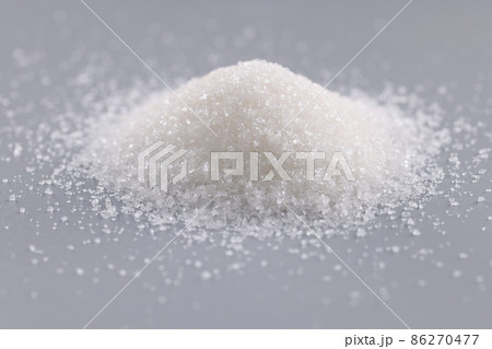 Pile of sugar crystals on grey surface, focus on heap of sweet powder to add in dishes Pile of sugar crystals on grey surface, focus on heap of sweet powder to add in dishes 86270477