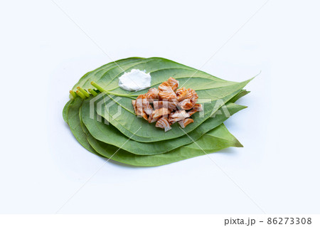 Chewing betel nut, Betel nut with cal lime powder on betel leaves 86273308