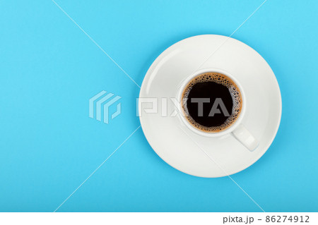 Full white espresso coffee cup over blue Full white espresso coffee cup over blue 86274912