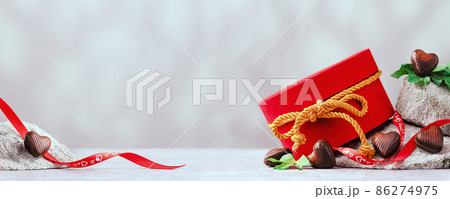 Several chocolate hearts on gray stones banner Several chocolate hearts on gray stones banner 86274975