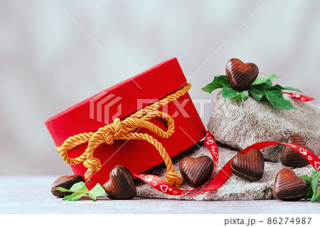 Several chocolate hearts on gray stones banner 86274987