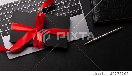 Gift box over laptop on office desk table 86275205