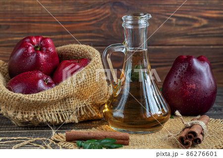 Apple cider vinegar and red apples on a dark, wooden background. Selective focus. fermented product. Healthy food. 86276601
