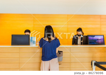 Woman guest check in with receptionist at hotel counter. Woman guest check in with receptionist at hotel counter. 86278096