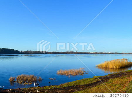 Urban landscape in october with blue sky and autumn trees. 86279410