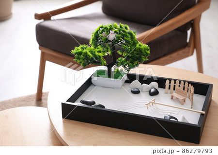 Beautiful miniature zen garden on wooden table indoors Beautiful miniature zen garden on wooden table indoors 86279793