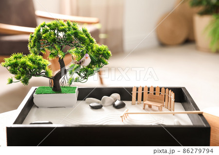 Beautiful miniature zen garden on wooden table indoors Beautiful miniature zen garden on wooden table indoors 86279794