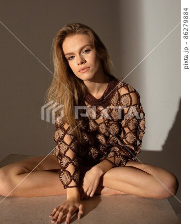 Pretty blond woman in sunset light Pretty blond woman in sunset light 86279884