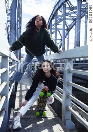 young cute teenage girls together in industrial zone happy smiling having fun, big city lifestyle fashion people young cute teenage girls together in industrial zone happy smiling having fun, big city lifestyle fashion people 86281069