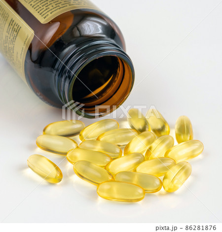 Gelatin capsules with omega-3 and glass bottle on a light background Gelatin capsules with omega-3 and glass bottle on a light background 86281876