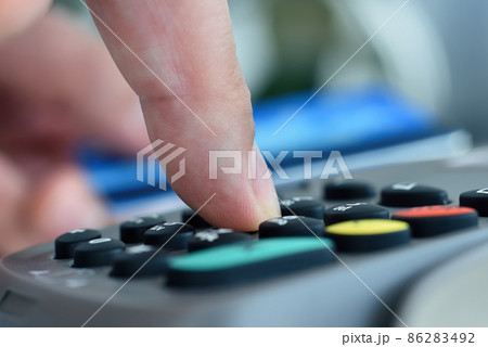 Finger dials pin code on terminal. Finger dials pin code on terminal. 86283492