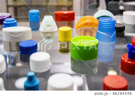 different colors of plastic lids and containers of different shapes and purposes 86294348