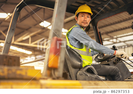 Engineer Man forklift driver with a background in an industrial or warehousing factory. Engineer Man forklift driver with a background in an industrial or warehousing factory. 86297353