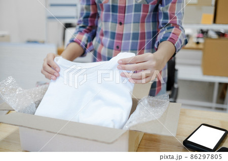Online business owner preparing product to customer. Online business owner preparing product to customer. 86297805