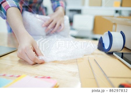 Online business owner preparing product to customer. 86297832