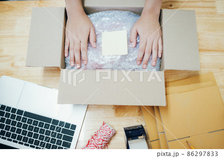 Online business owner preparing product to customer. 86297833