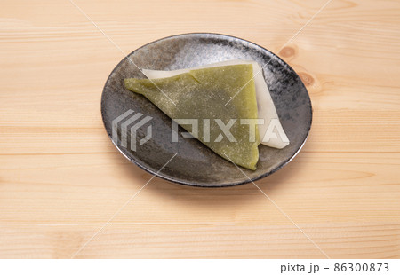 Yatsuhashi traditional kyoto sweets on black plate on woodle background. Japanese dessert Yatsuhashi traditional kyoto sweets on black plate on woodle background. Japanese dessert 86300873