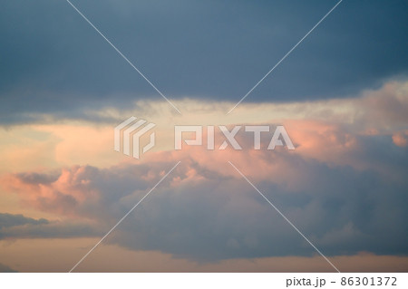 Thick clouds in sundown sky Thick clouds in sundown sky 86301372