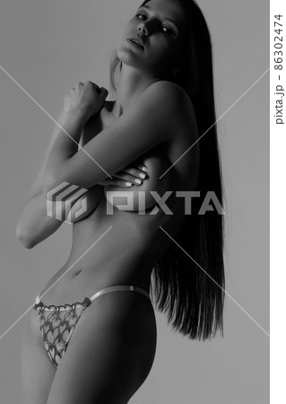 Topless woman in lingerie in studio 86302474