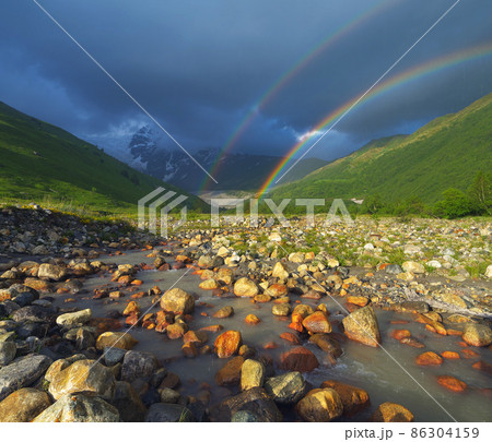 Rainbow in the mountains 86304159