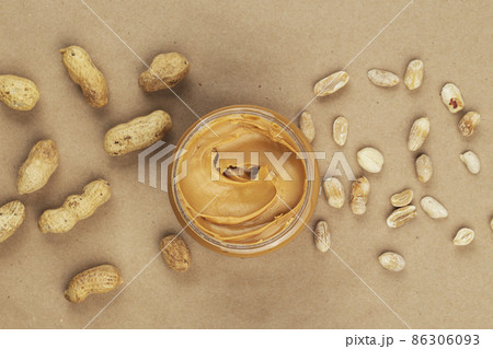Creamy and smooth peanut butter in jar on paper table. Creamy and smooth peanut butter in jar on paper table. 86306093