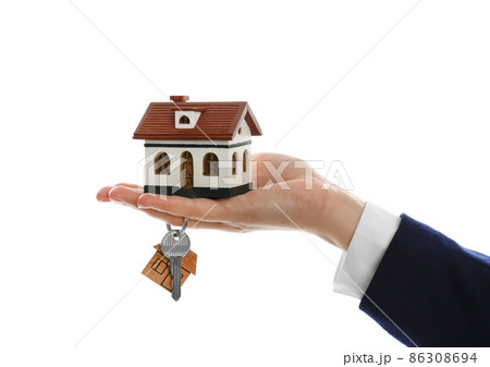 Real estate agent holding house model and key on white background, closeup Real estate agent holding house model and key on white background, closeup 86308694