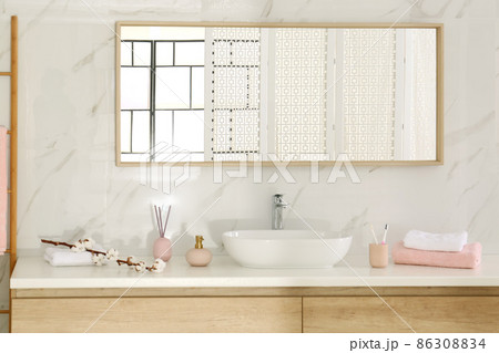 Large mirror over vessel sink in stylish bathroom interior 86308834