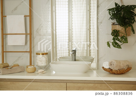 Large mirror and vessel sink in stylish bathroom Large mirror and vessel sink in stylish bathroom 86308836