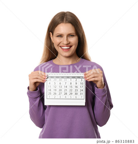 Excited young woman holding calendar with marked menstrual cycle days on beige background 86310883