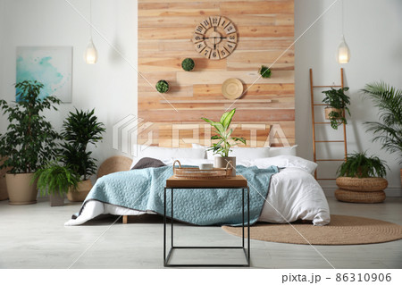Stylish bedroom interior with green plants. Home design ideas 86310906