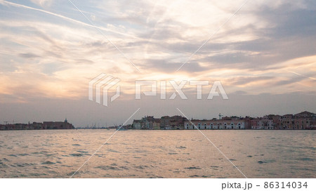 Venice lagoon on sunset, Italy. Old italian architecture in Venezia. Travel Background for a poster, calendar, poster, screensaver, wallpaper, postcard, banner, cover, a place to copy your design or Venice lagoon on sunset, Italy. Old italian architecture in Venezia. Travel Background for a poster, calendar, poster, screensaver, wallpaper, postcard, banner, cover, a place to copy your design or 86314034