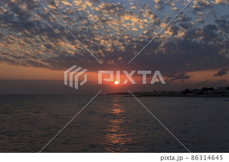 Sunrise over the sea in Kokkini Hani, Crete, Greece. Scenic seaside landscape in the morning. 86314645