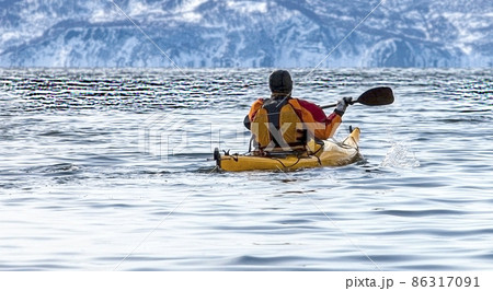 kayaker on a boat in the calm sea on Kamchatka Peninsula kayaker on a boat in the calm sea on Kamchatka Peninsula 86317091
