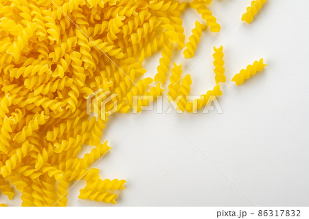 Uncooked fusilli pasta on white background. 86317832