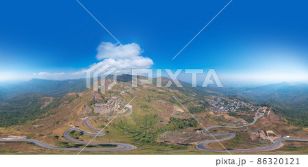 360 panorama by 180 degrees angle seamless panorama of aerial view of cars driving on curved, zigzag curve road or street on mountain hill in rural area of Nan, Thailand. Transportation. 86320121